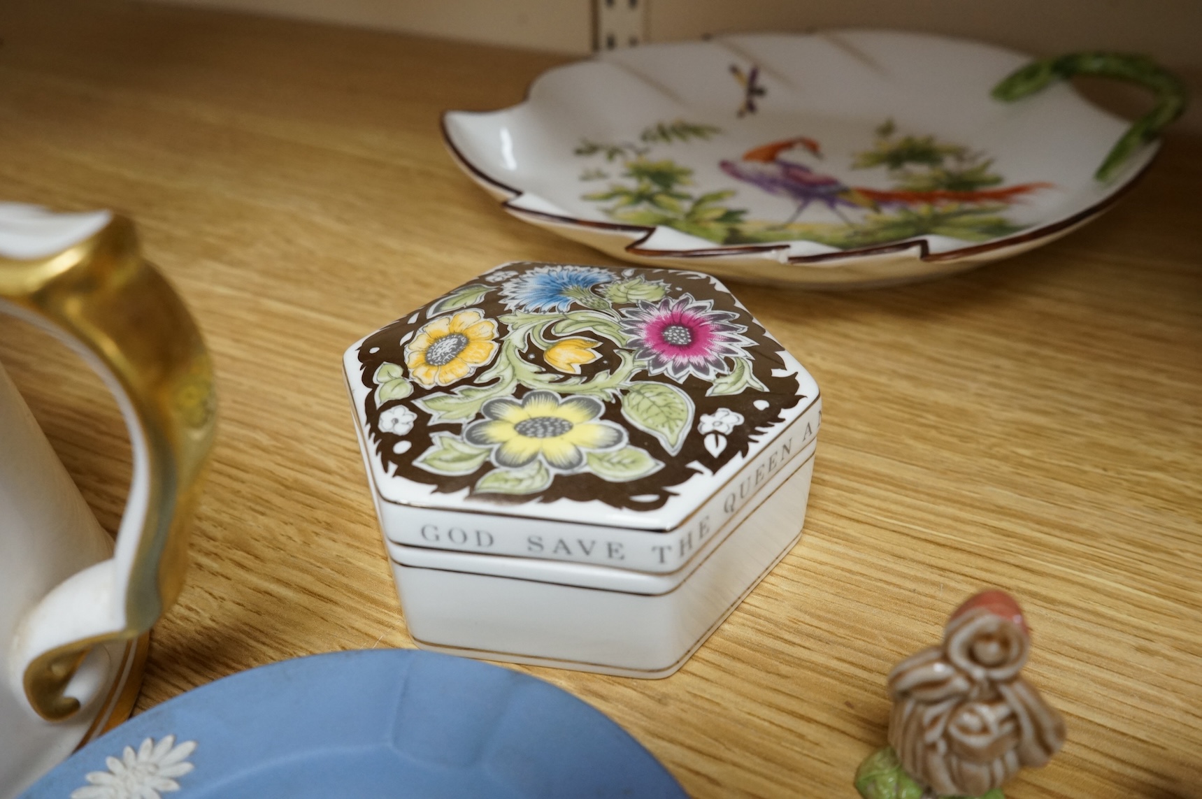 A collection of porcelain and pottery to include commemorative china, a leaf dish and group of wade figures, largest 29cm in diameter